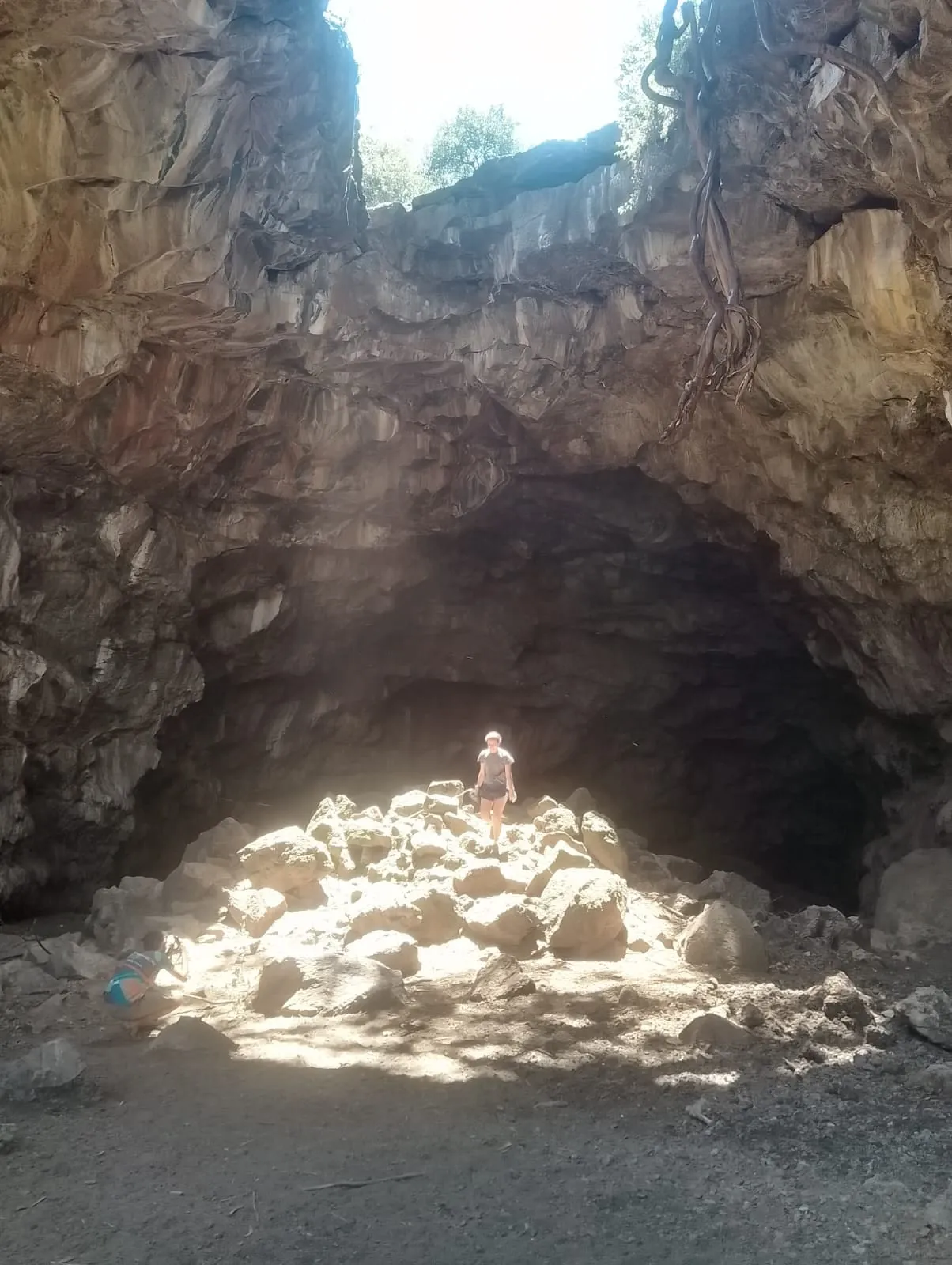 Sunlight falling through the roof of a lava cave on Mount Suswa onto a pile of rocks