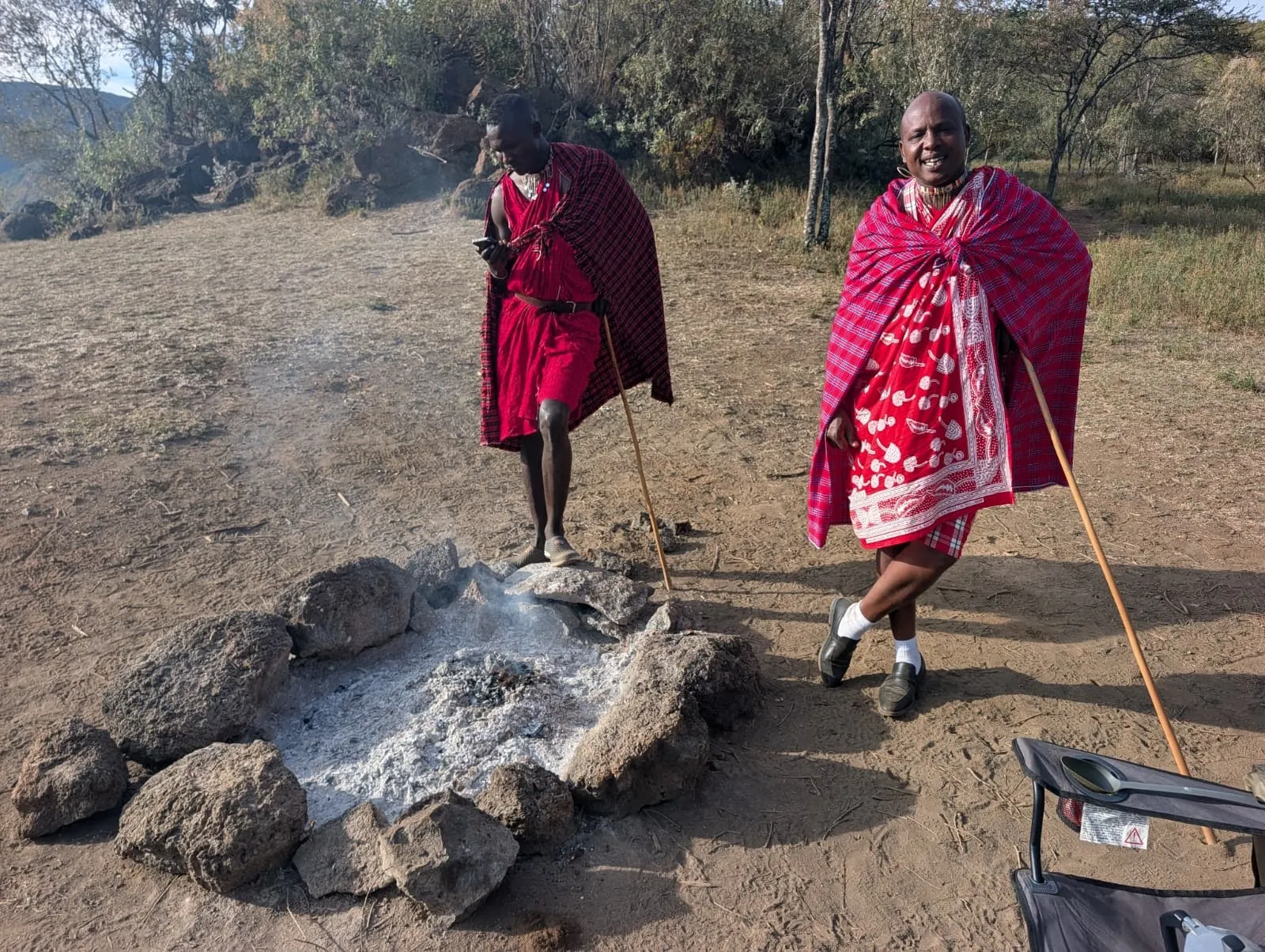 Two guides next to the fire pit at camp